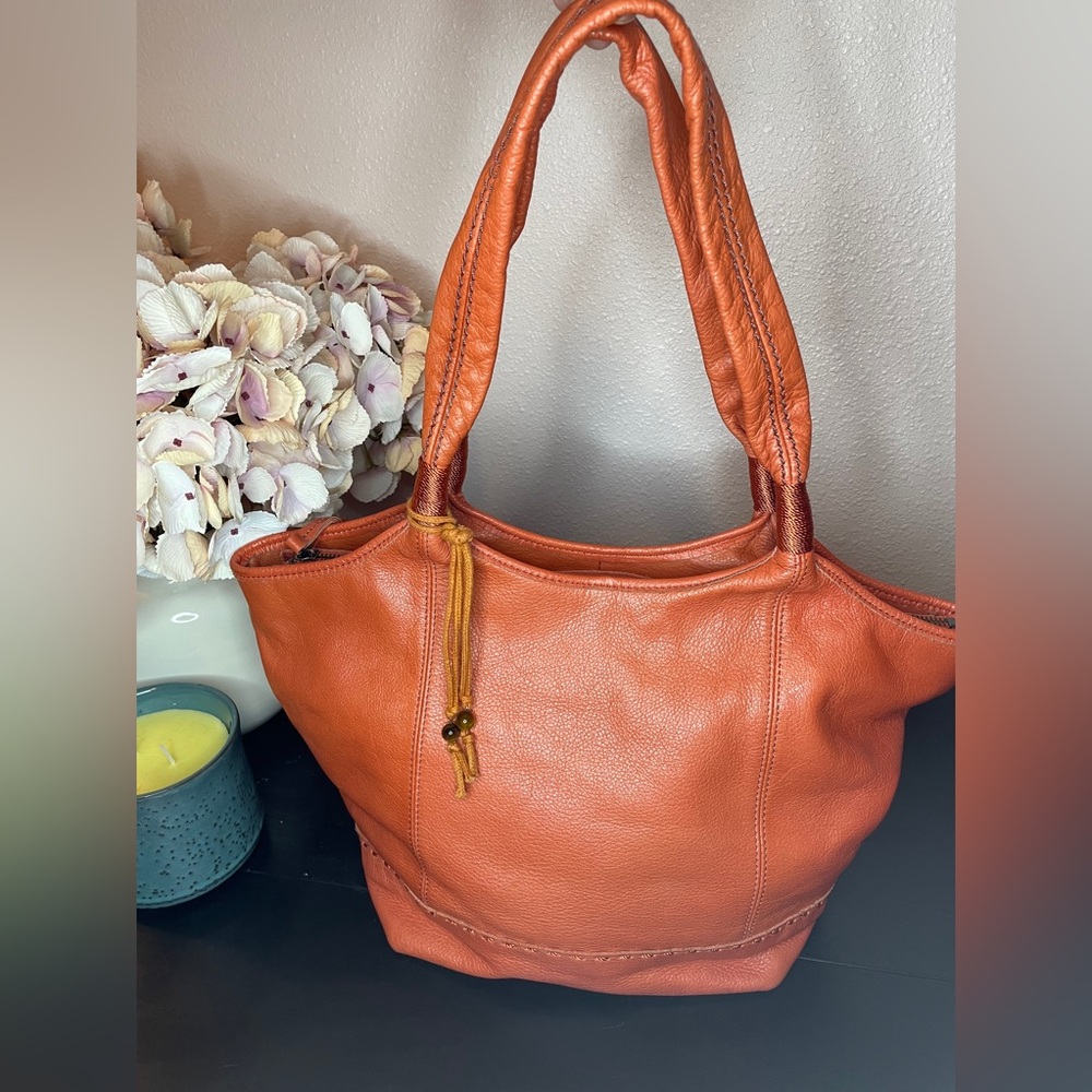 The Sak Leather Orange Bucket Bag with two wide straps.  Two interior pockets. - Picture 2 of 3